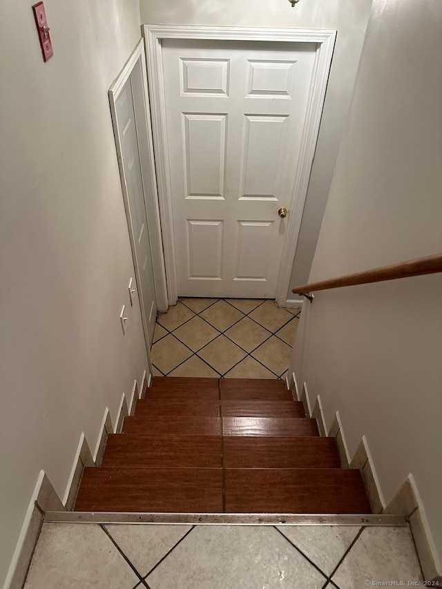 stairway with tile patterned flooring