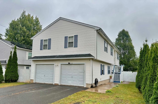 view of side of property featuring a garage and a yard