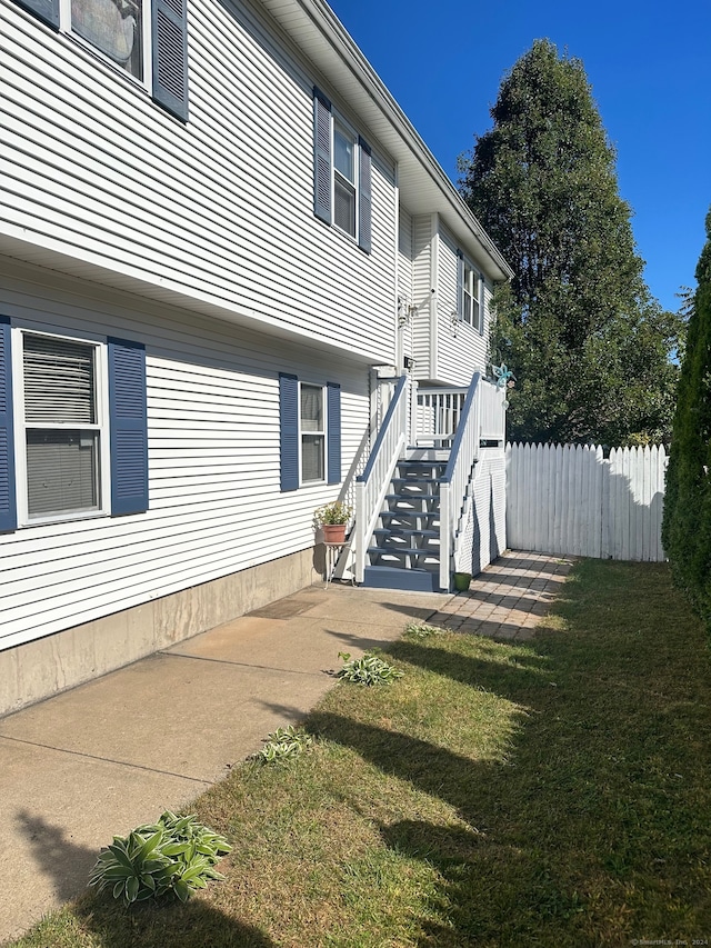 view of property exterior featuring a lawn