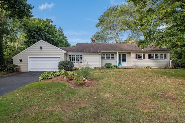 ranch-style house with a garage and a front lawn