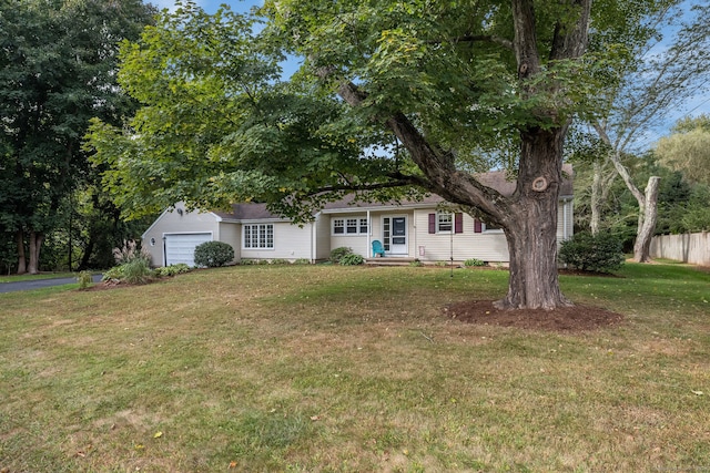 view of front of home with a garage, a front lawn, and an outdoor structure