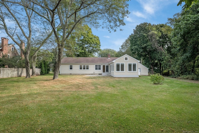 back of property featuring a lawn