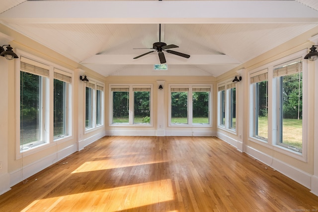 unfurnished sunroom featuring ceiling fan and vaulted ceiling with beams