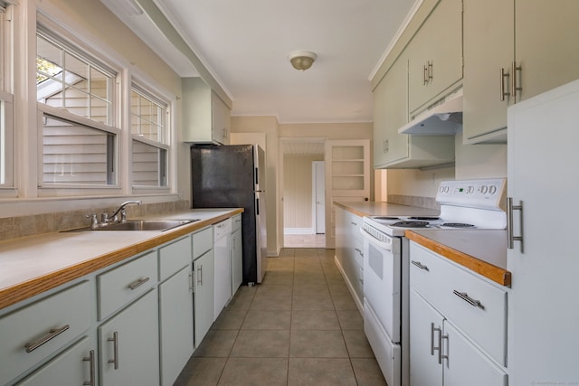 kitchen featuring light tile patterned flooring, white cabinets, sink, and white appliances