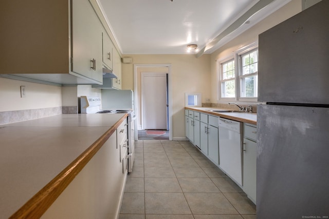 kitchen featuring white cabinets, light tile patterned flooring, sink, and white appliances