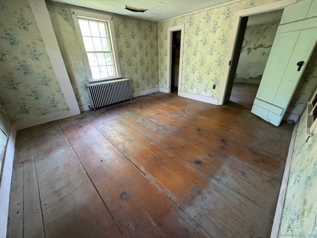 interior space with radiator and hardwood / wood-style floors