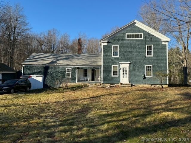 view of front facade with covered porch and a front yard