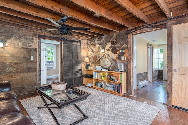 living room featuring beam ceiling, a baseboard radiator, a barn door, and dark hardwood / wood-style floors