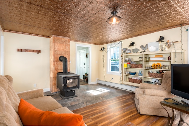 living room with ornamental molding, a wood stove, a baseboard heating unit, and dark wood-type flooring