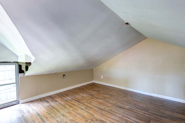 bonus room with hardwood / wood-style flooring and lofted ceiling