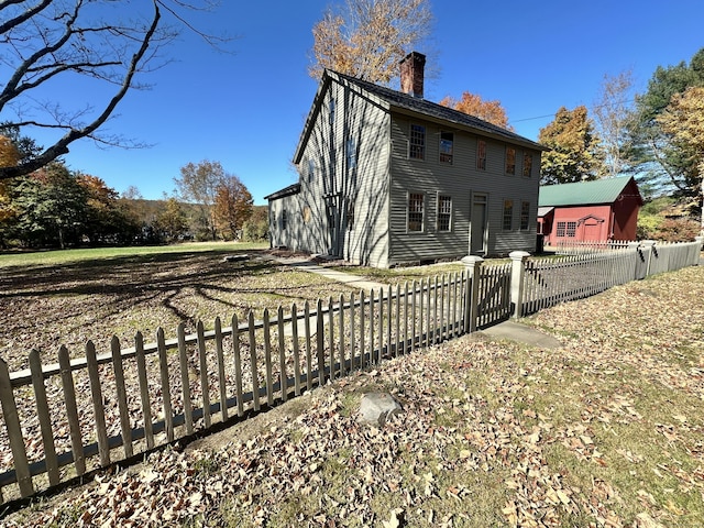 27 Middle Quarter Rd, Woodbury, CT 06798 - back of property featuring a chimney and a fenced front yard
