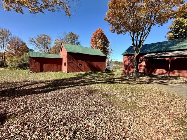 27 Middle Quarter Rd, Woodbury, CT 06798 - view of side of home featuring an outbuilding, a metal roof, and a yard