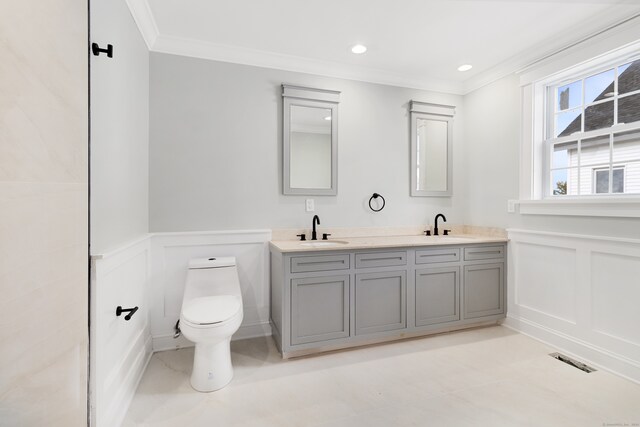 bathroom with crown molding, vanity, and toilet