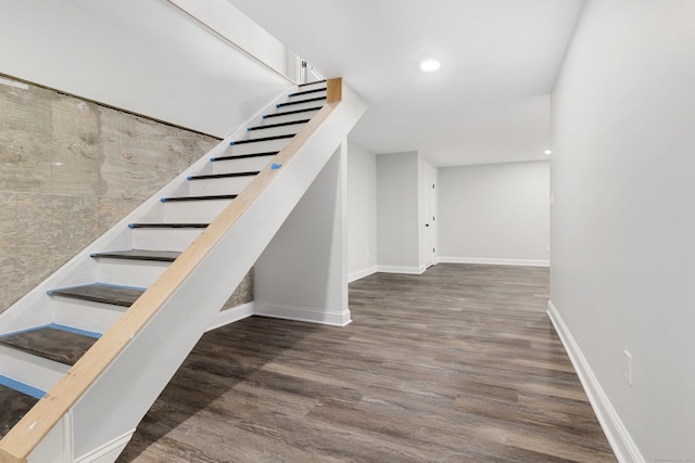 stairway with hardwood / wood-style flooring