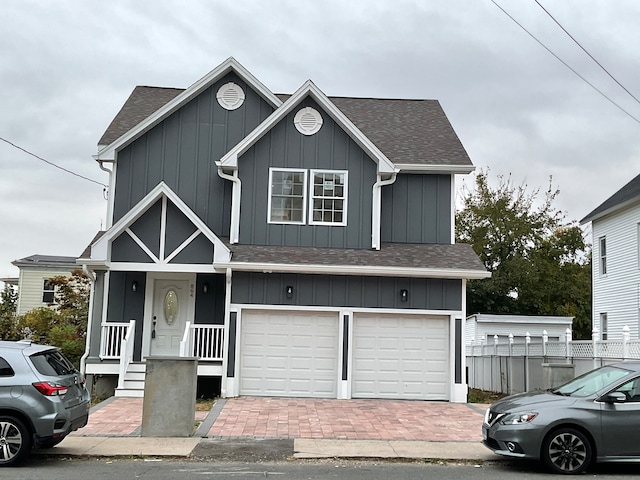 view of front of home with a porch and a garage