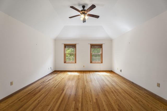 unfurnished room featuring ceiling fan, light hardwood / wood-style floors, and vaulted ceiling