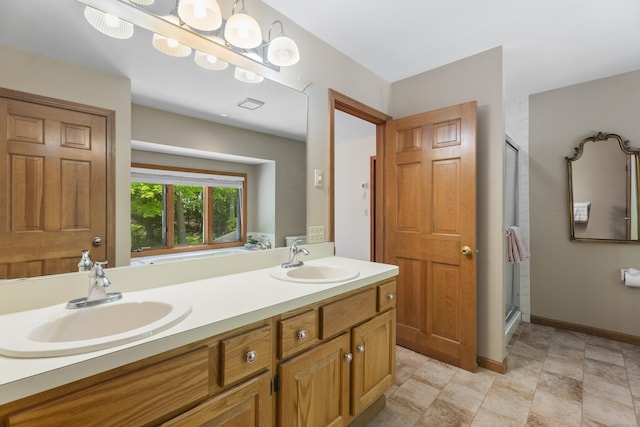 bathroom with vanity and a shower with door