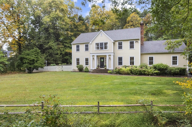 colonial home with a front lawn