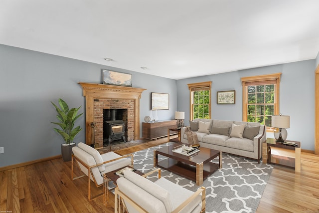 living room featuring light wood-type flooring and a wood stove