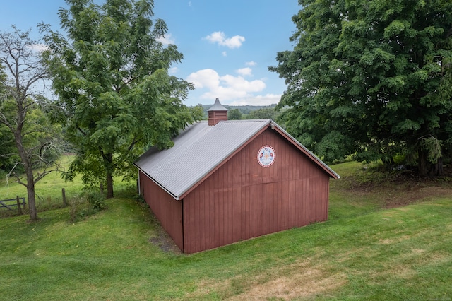 view of outbuilding with a lawn