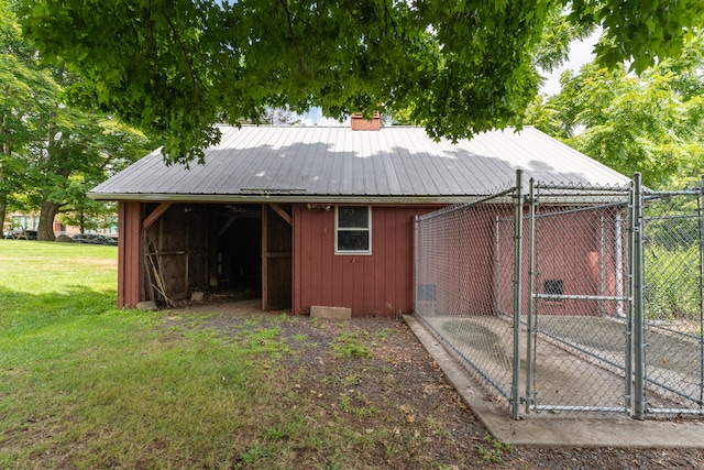 view of outbuilding featuring a yard