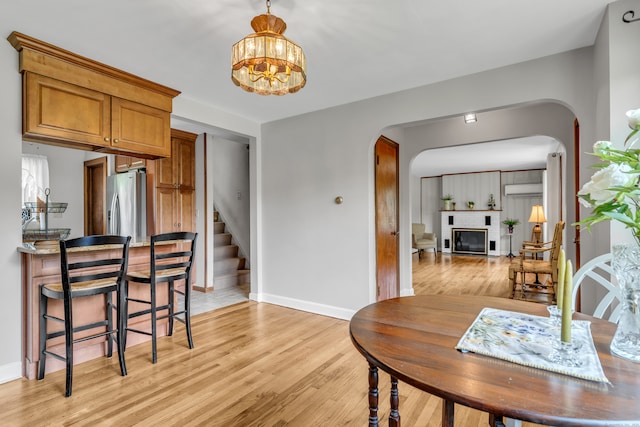 dining room with an inviting chandelier and light hardwood / wood-style floors