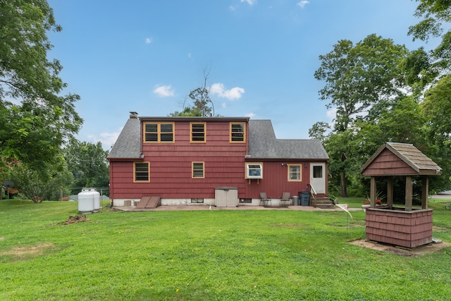 rear view of property featuring a yard