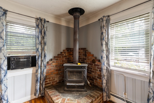 room details featuring crown molding, a wood stove, and hardwood / wood-style flooring