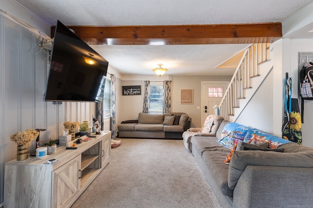 carpeted living room with a textured ceiling and beam ceiling