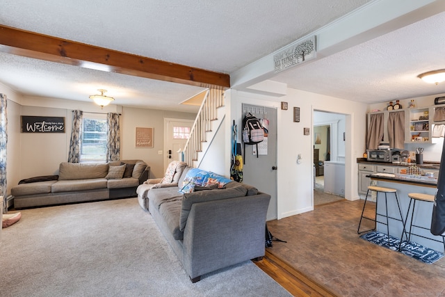 living room with wood-type flooring, a textured ceiling, and beamed ceiling