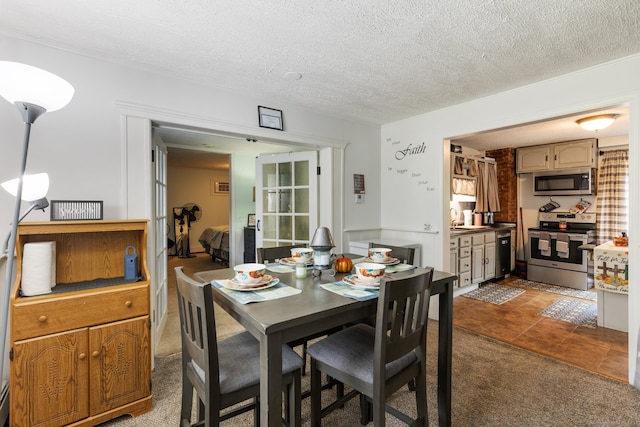 dining area with carpet floors, a textured ceiling, and sink