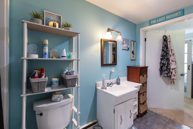 bathroom with tile patterned flooring, vanity, and toilet