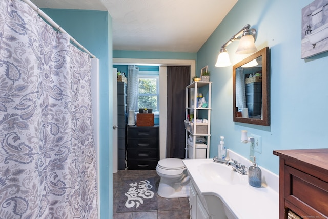 bathroom featuring tile patterned floors, vanity, and toilet