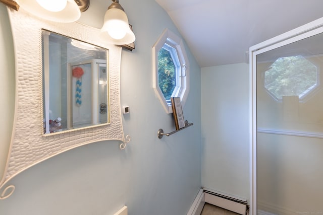 bathroom featuring lofted ceiling and a baseboard heating unit