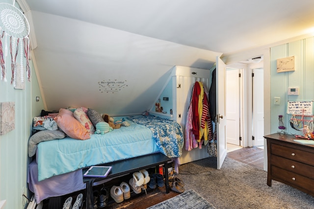 bedroom featuring vaulted ceiling and light carpet