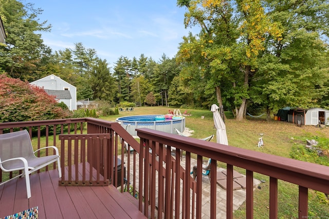 wooden deck with a shed and a yard