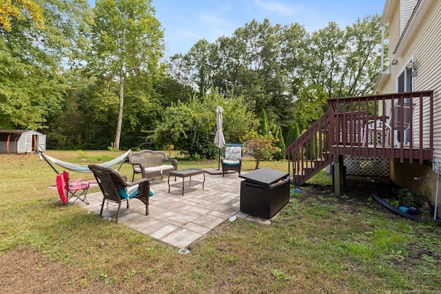 view of yard with a deck, a patio area, a shed, and a fire pit