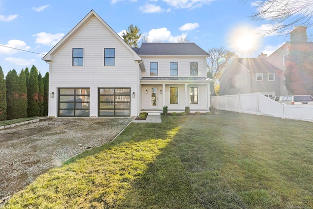 view of front facade with a porch, a garage, and a front yard