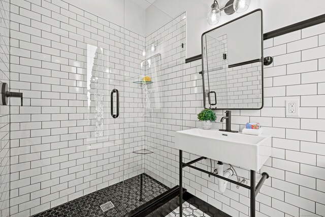 bathroom with tile walls and walk in shower