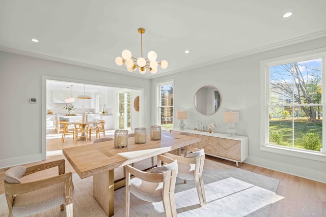 dining space featuring a chandelier, crown molding, and light hardwood / wood-style floors