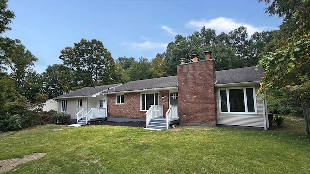 rear view of property featuring a yard