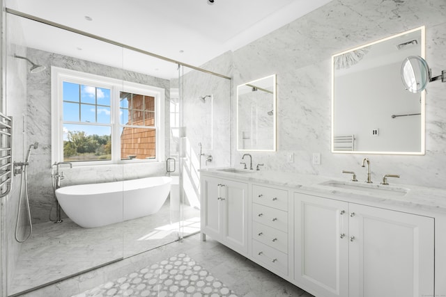 bathroom featuring shower with separate bathtub, vanity, and tile walls