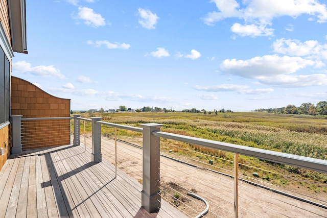 wooden terrace featuring a rural view