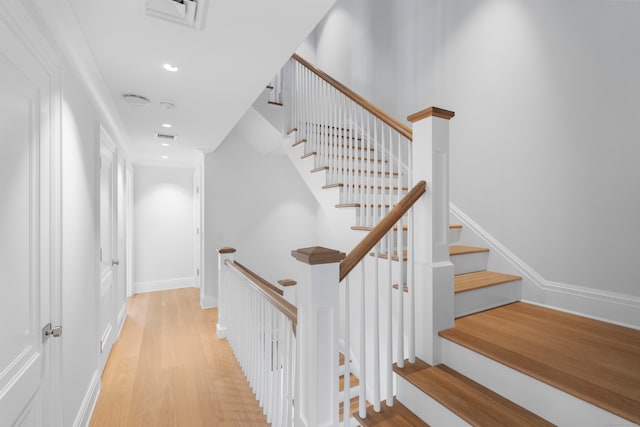 staircase with wood-type flooring