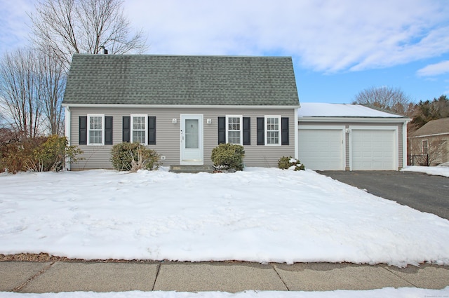 view of front of home featuring roof with shingles, driveway, and an attached garage