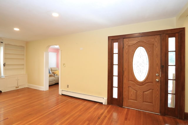 25 Muriel St, Norwalk, CT 06851 - entrance foyer with arched walkways, baseboard heating, wood finished floors, baseboards, and recessed lighting