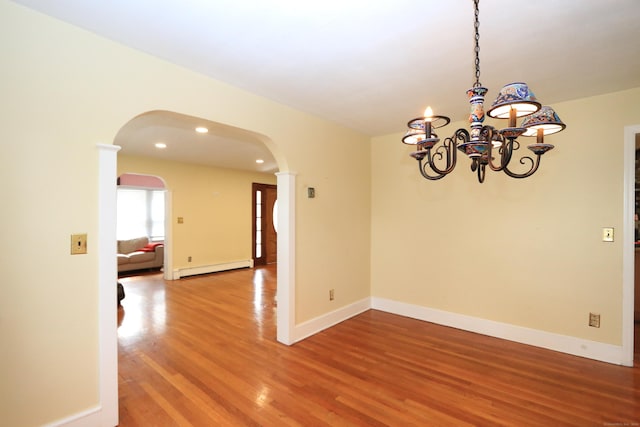 25 Muriel St, Norwalk, CT 06851 - spare room featuring arched walkways, a chandelier, baseboards, wood finished floors, and a baseboard radiator