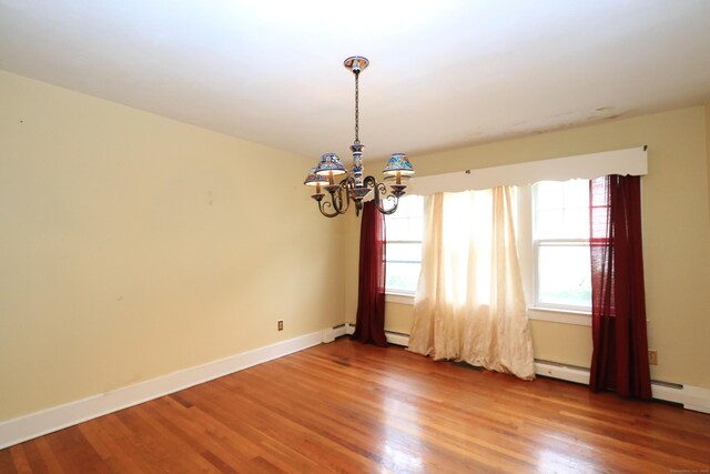 25 Muriel St, Norwalk, CT 06851 - unfurnished room with baseboards, baseboard heating, wood finished floors, and a notable chandelier