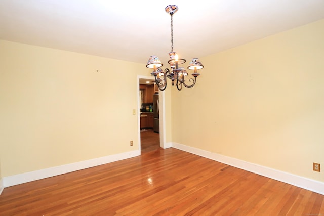 25 Muriel St, Norwalk, CT 06851 - unfurnished room with light wood-style floors, baseboards, and a chandelier