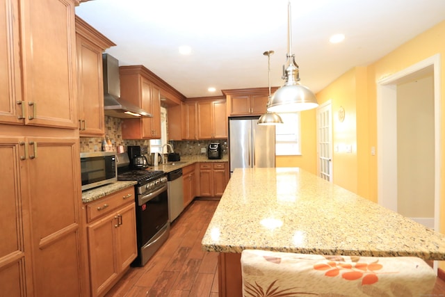 25 Muriel St, Norwalk, CT 06851 - kitchen with appliances with stainless steel finishes, tasteful backsplash, a center island, wood finished floors, and wall chimney exhaust hood